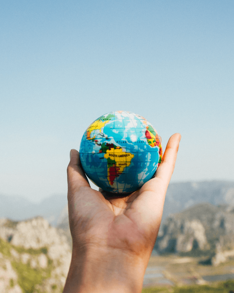 A lady holding the world map on her palms ( Wedding around the world)
