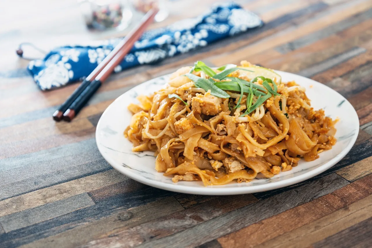 Pad Thai, vegan recipe made with rice noodles, vegetables and peanuts cooked on wok